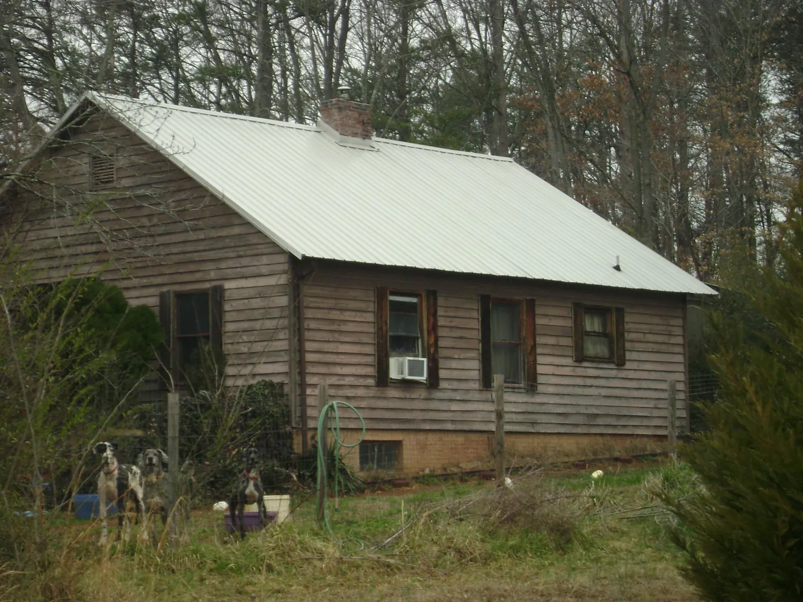 White metal roof on an old wood sided farmhouse, from a Metal Roof Installation job in Durango